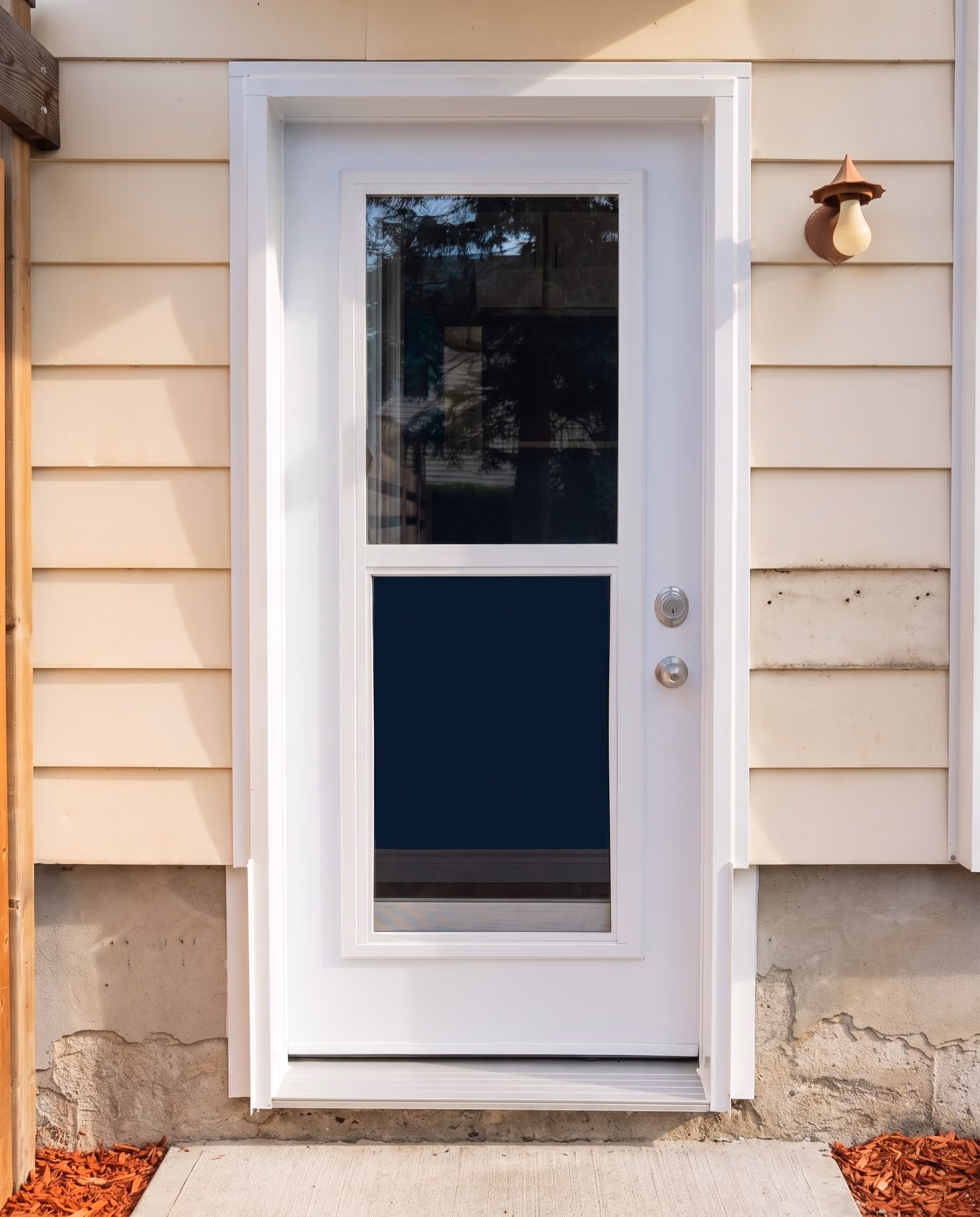 White-framed glazed service door seen head-on.
